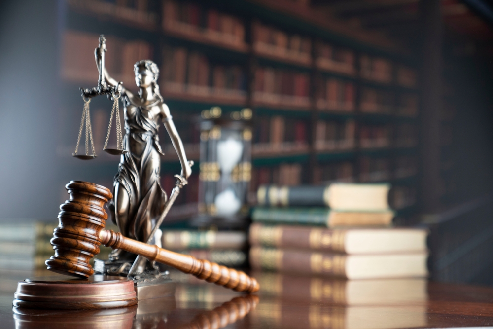 Law,Symbols.,Library,Background.,Gavel,,Wooden,Table,,Books. law symbols with gavel on wooden table and law books in library background