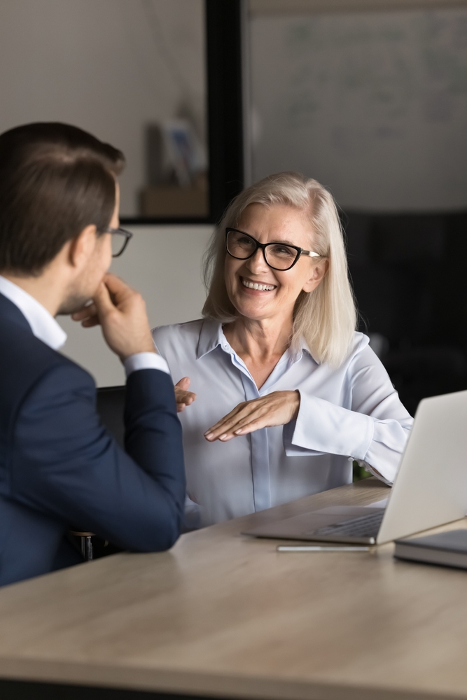 woman and man having a conversation at desk